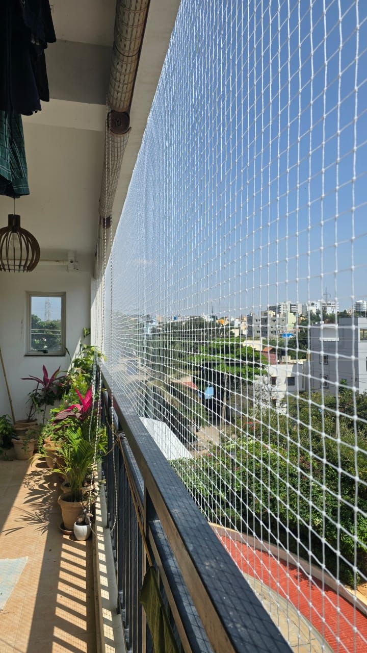 Balcony safety net installation with clear city view
