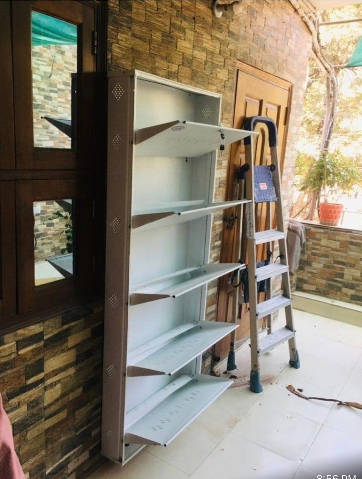 White multi-tier flip-out shoe rack in a Bangalore apartment
